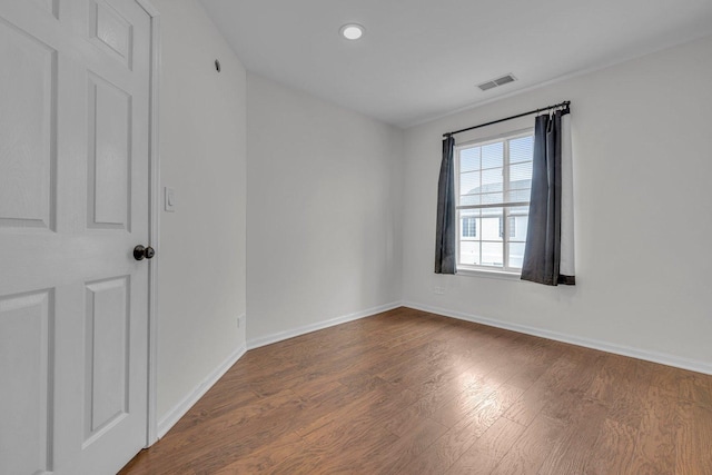 empty room with dark hardwood / wood-style flooring