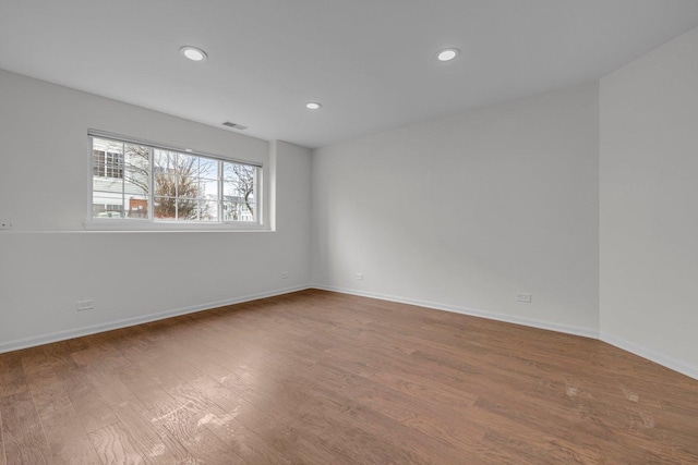 spare room with hardwood / wood-style floors