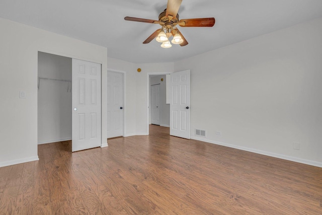 unfurnished bedroom with hardwood / wood-style floors, a closet, and ceiling fan