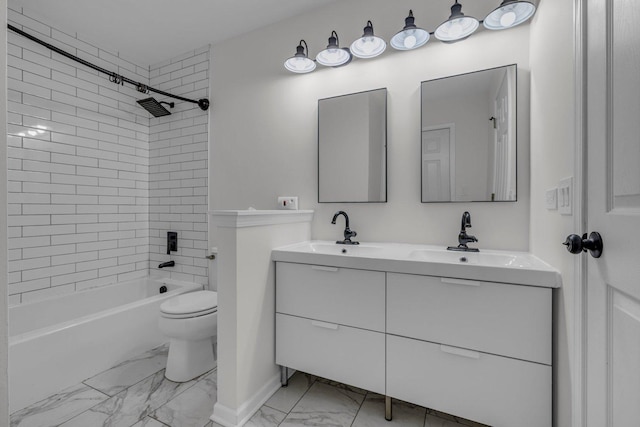 full bathroom featuring tiled shower / bath, vanity, and toilet