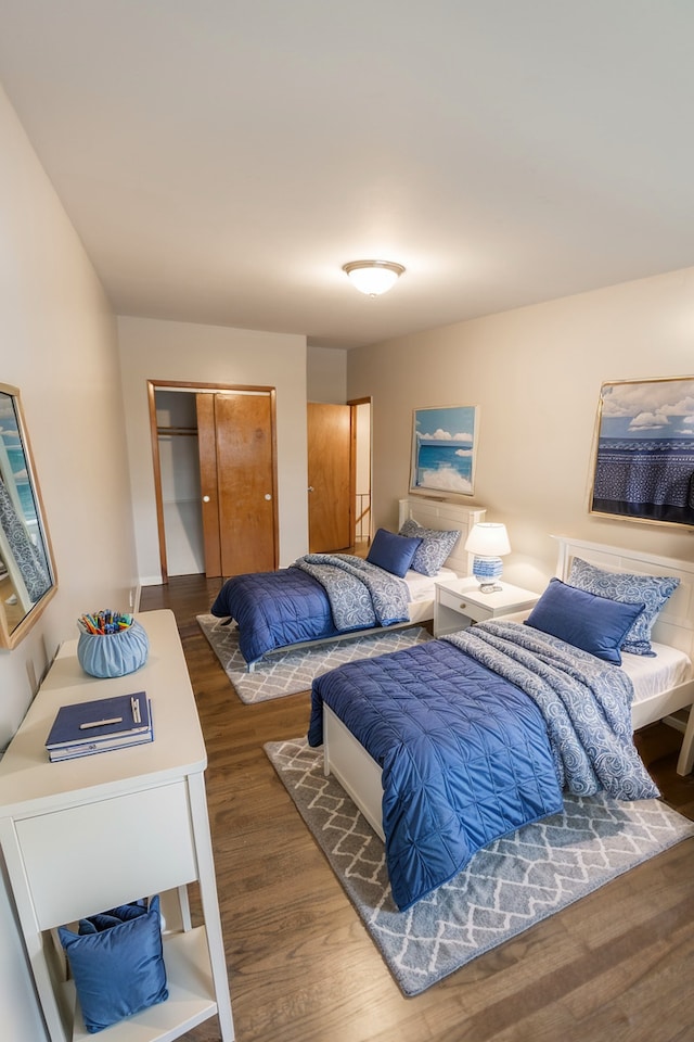 bedroom featuring dark hardwood / wood-style floors and a closet