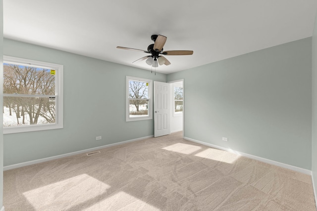 carpeted empty room featuring ceiling fan