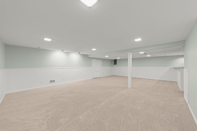 basement featuring light carpet