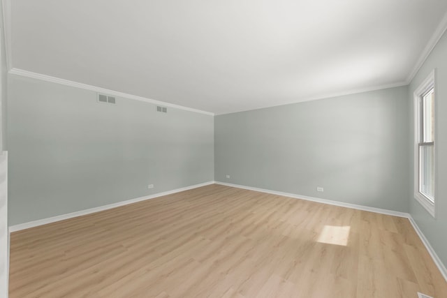 unfurnished room featuring crown molding and light hardwood / wood-style flooring