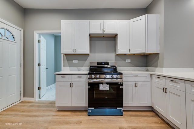 kitchen featuring stainless steel range with electric stovetop, light wood-type flooring, and white cabinets