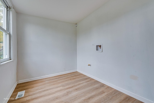 spare room featuring plenty of natural light and light wood-type flooring