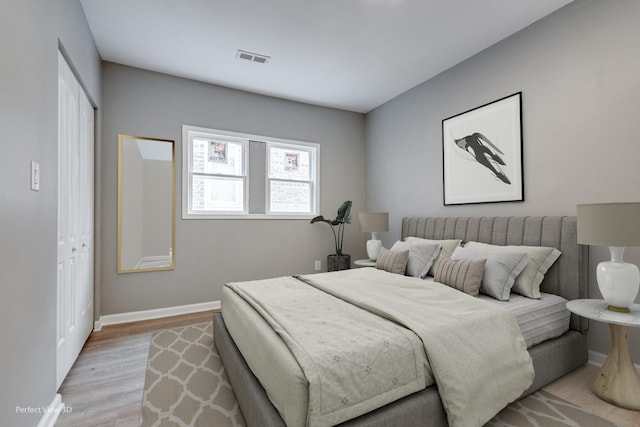 bedroom with light hardwood / wood-style flooring and a closet