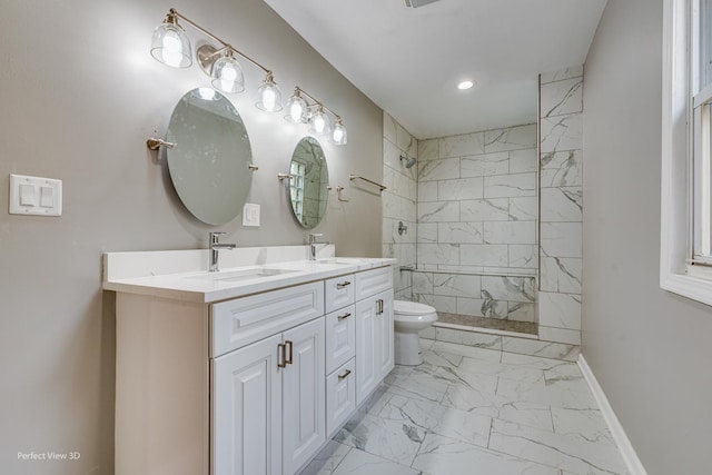 bathroom featuring vanity, a tile shower, and toilet