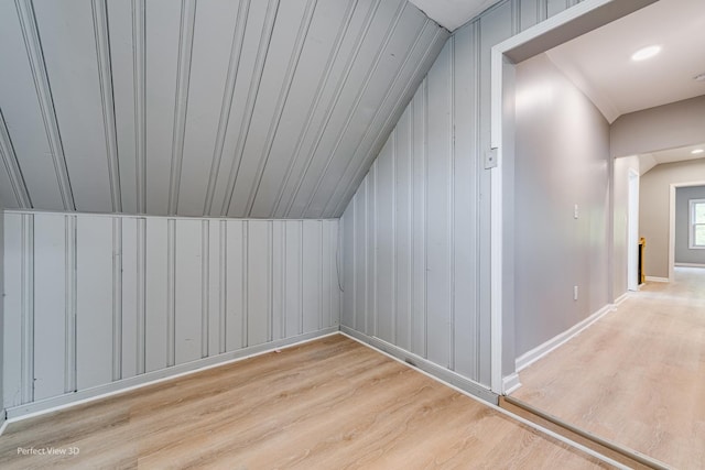 bonus room with lofted ceiling and light hardwood / wood-style flooring