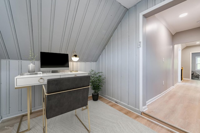 office with lofted ceiling and light hardwood / wood-style floors