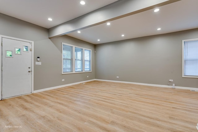 foyer featuring beam ceiling and light hardwood / wood-style flooring