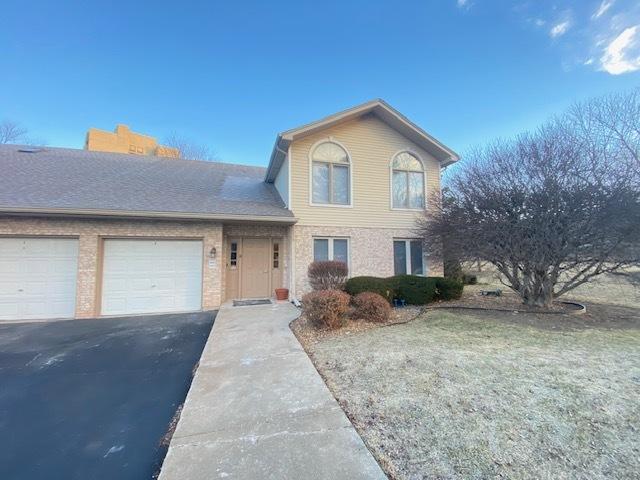 front of property with a garage and a front yard