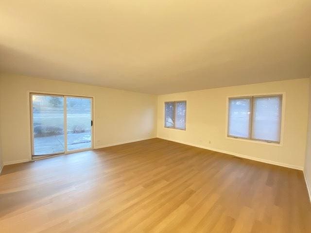 empty room with hardwood / wood-style flooring