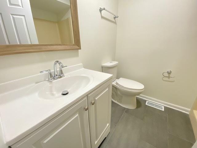 bathroom with vanity, tile patterned floors, and toilet