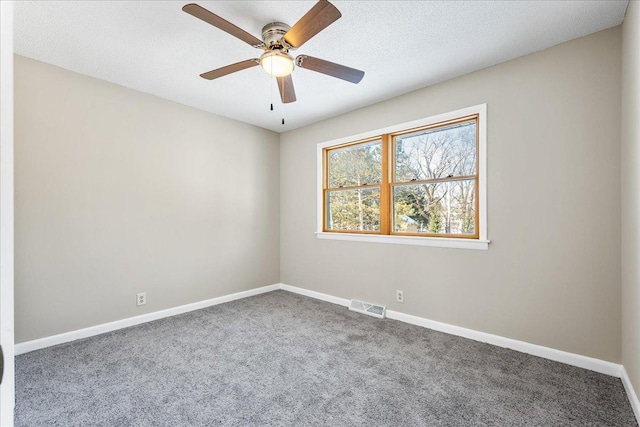 empty room featuring carpet, a textured ceiling, and ceiling fan