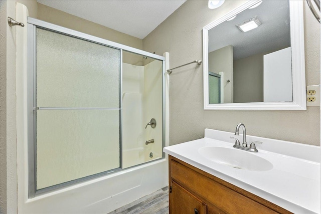 bathroom with vanity, combined bath / shower with glass door, and wood-type flooring