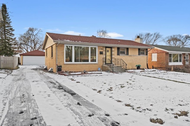 view of front facade featuring a garage and an outdoor structure