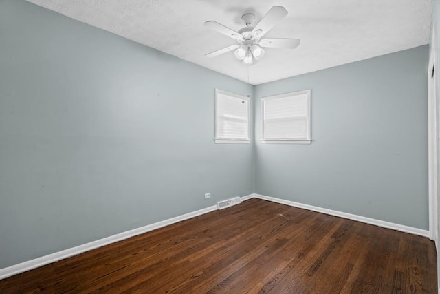 unfurnished room featuring ceiling fan and dark hardwood / wood-style floors