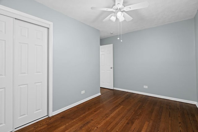 unfurnished bedroom with dark wood-type flooring and ceiling fan