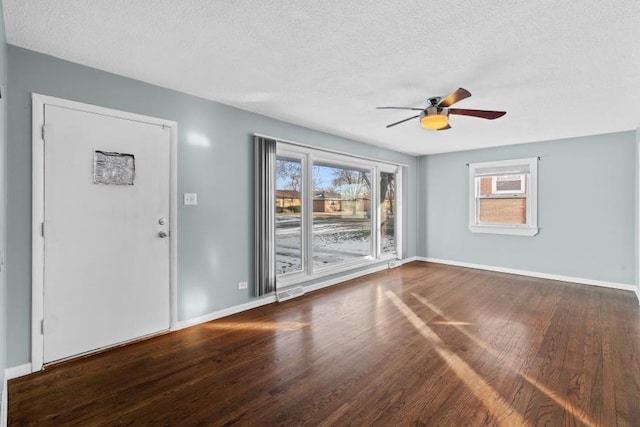 empty room featuring wood-type flooring, ceiling fan, and a textured ceiling