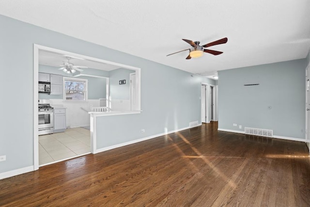 unfurnished living room with ceiling fan and light hardwood / wood-style flooring