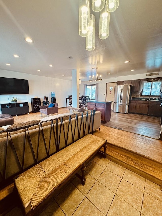 interior space with light tile patterned flooring and a notable chandelier