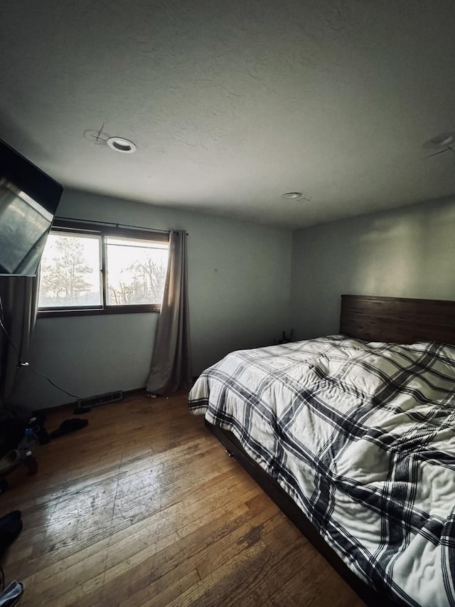 bedroom with wood-type flooring