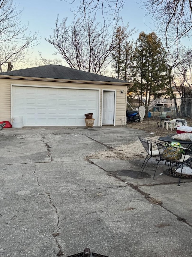 view of garage at dusk