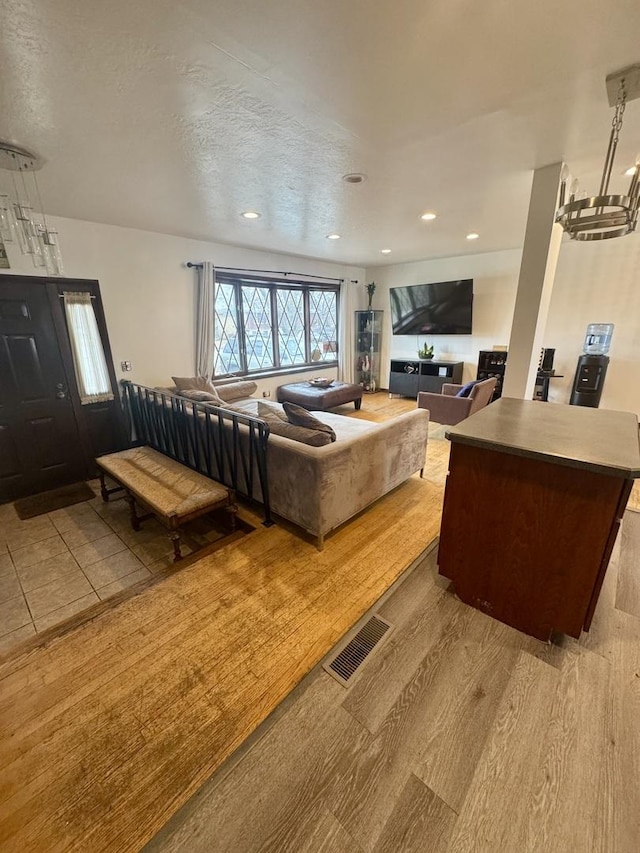 living room featuring a textured ceiling and light wood-type flooring