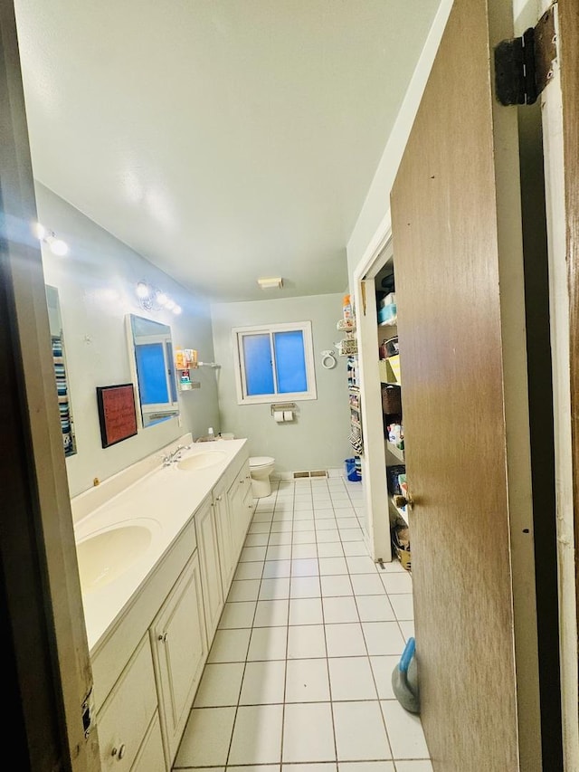 bathroom featuring vanity, tile patterned floors, and toilet