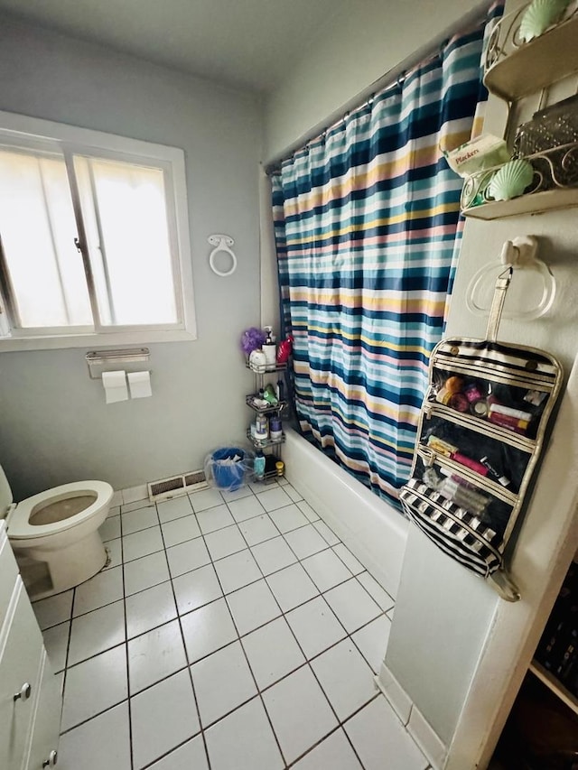 bathroom with shower / bath combination with curtain, tile patterned floors, and toilet