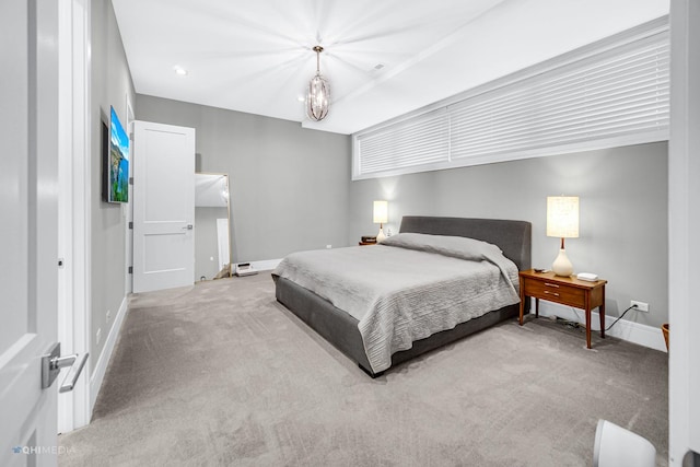 bedroom with light carpet and a chandelier