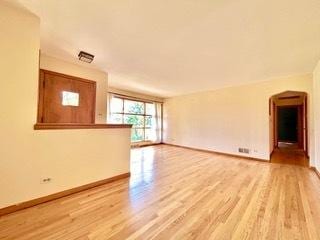 unfurnished living room with light wood-type flooring