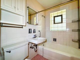 bathroom featuring decorative backsplash, tiled shower / bath, toilet, and tile walls