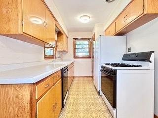 kitchen with sink, black dishwasher, and white gas stove