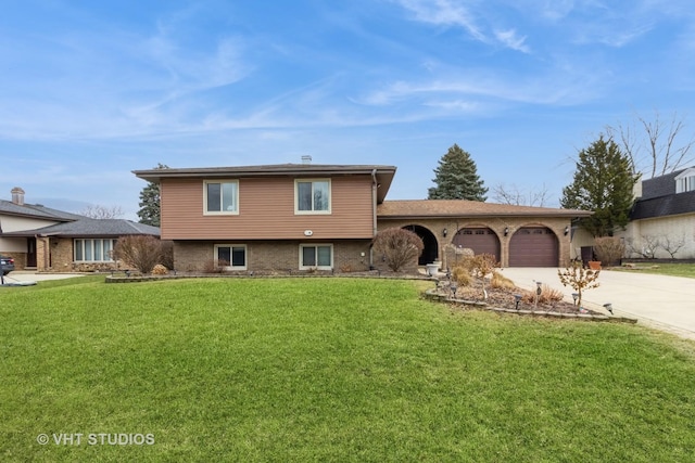 split level home with a garage and a front yard