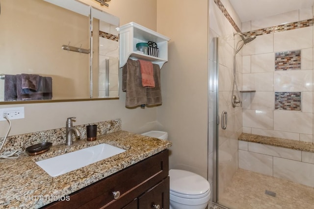 bathroom with vanity, toilet, and an enclosed shower