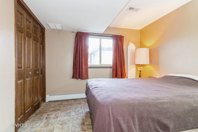 bedroom with a baseboard radiator and a closet