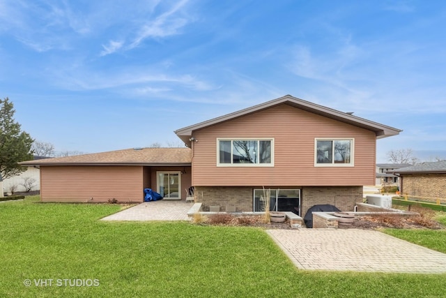 rear view of property featuring a patio area and a lawn