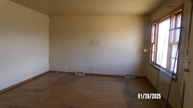 empty room with hardwood / wood-style flooring