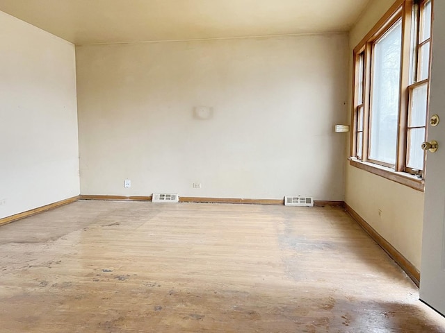 empty room with light hardwood / wood-style floors