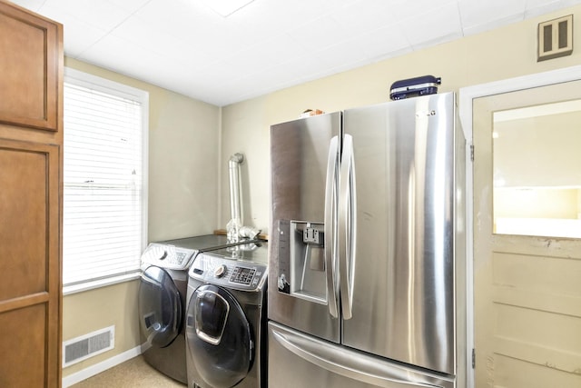 laundry area with washing machine and clothes dryer