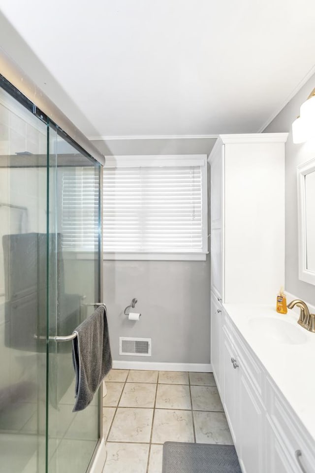 bathroom with walk in shower, tile patterned floors, vanity, and ornamental molding