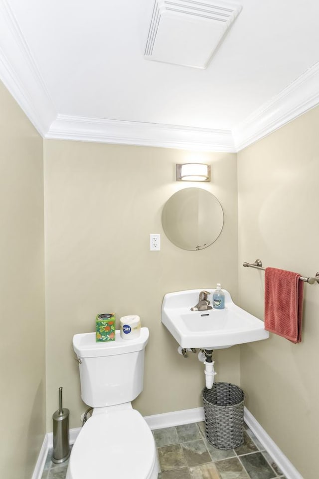 bathroom featuring sink, crown molding, and toilet