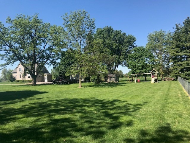 view of yard featuring a storage shed and a playground