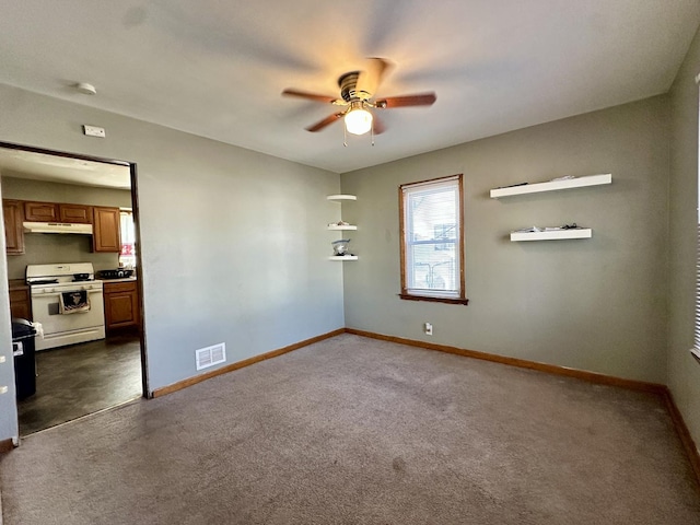 carpeted spare room featuring ceiling fan