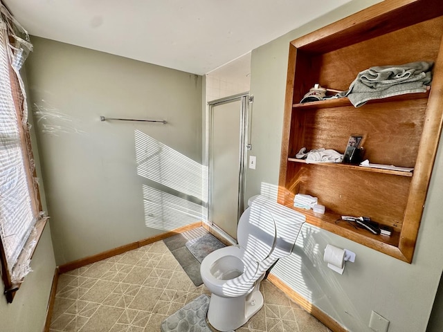 bathroom with a shower with door and toilet