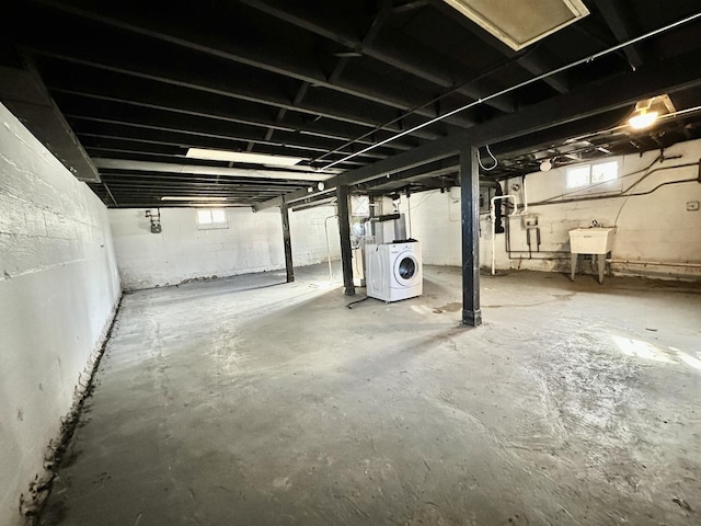 basement with sink and washer / dryer