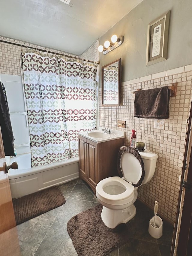 full bathroom featuring shower / tub combo with curtain, tile walls, tile patterned flooring, vanity, and toilet