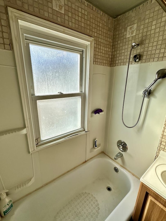 bathroom with vanity, bathtub / shower combination, and a wealth of natural light